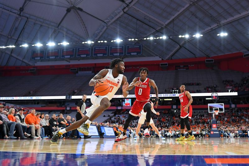 Feb 14, 2023; Syracuse, New York, USA; Syracuse Orange guard Symir Torrence (10) drives to the basket against the defense of North Carolina State Wolfpack guard Terquavion Smith (0) during the first half at the JMA Wireless Dome. Mandatory Credit: Rich Barnes-USA TODAY Sports