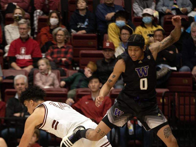 Feb 26, 2023; Stanford, California, USA; Washington Huskies guard Koren Johnson (0) jumps over Stanford Cardinal forward Spencer Jones (14) during the second half at Maples Pavilion. Mandatory Credit: D. Ross Cameron-USA TODAY Sports