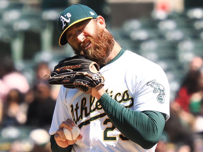 May 25, 2024; Oakland, California, USA; Oakland Athletics relief pitcher Austin Adams (29) before leaving the game against the Houston Astros during the seventh inning at Oakland-Alameda County Coliseum. Mandatory Credit: Kelley L Cox-USA TODAY Sports