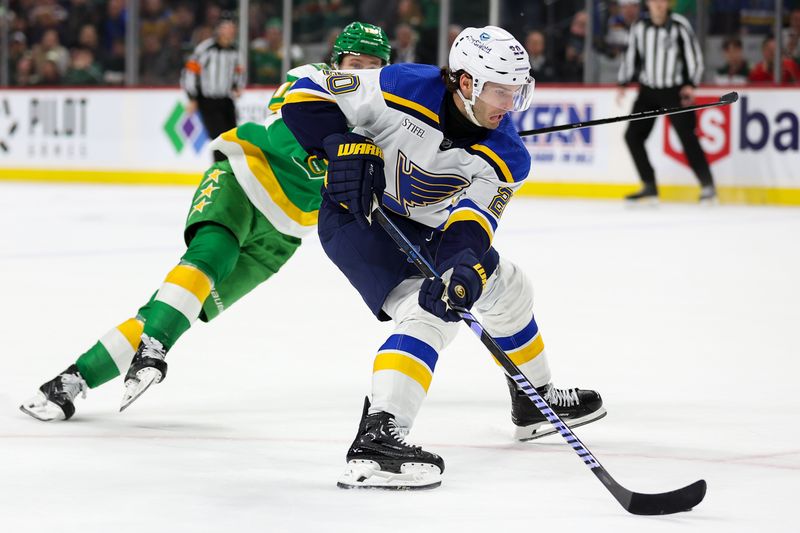 Mar 23, 2024; Saint Paul, Minnesota, USA; St. Louis Blues left wing Brandon Saad (20) skates with the puck as Minnesota Wild left wing Matt Boldy (12) defends during overtime at Xcel Energy Center. Mandatory Credit: Matt Krohn-USA TODAY Sports