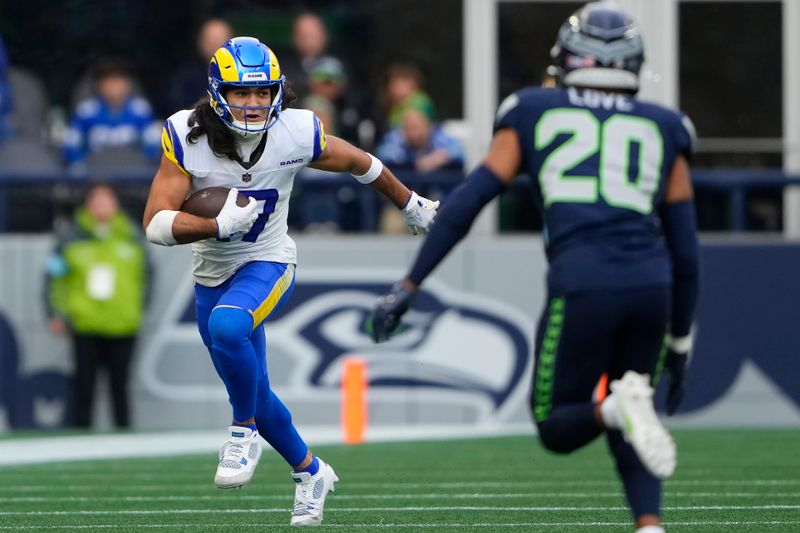 Los Angeles Rams wide receiver Puka Nacua, left, runs against Seattle Seahawks safety Julian Love (20) during the first half of an NFL football game in Seattle, Sunday, Nov. 3, 2024. (AP Photo/Lindsey Wasson)