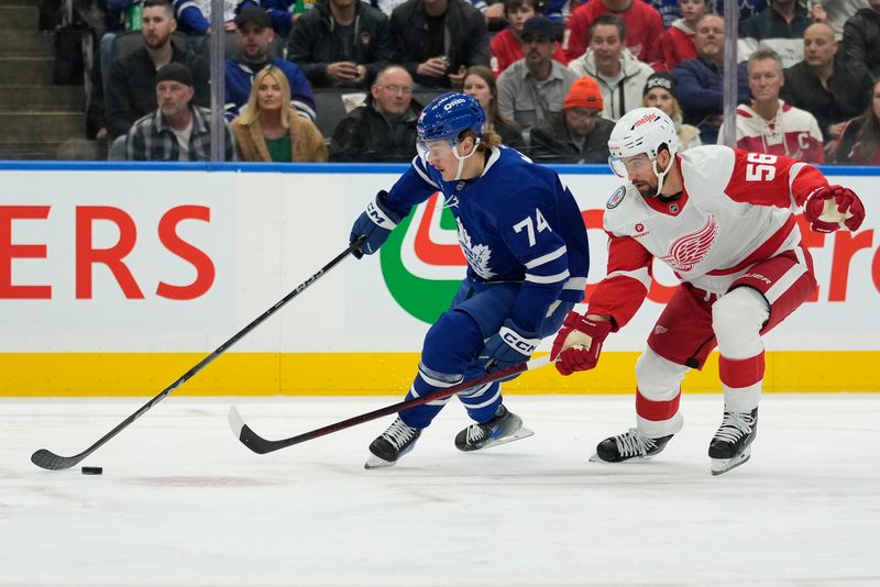 Nov 8, 2024; Toronto, Ontario, CAN; Toronto Maple Leafs forward Bobby McMann (74) battles to get around Detroit Red Wings defenseman Erik Gustafsson (56) during the first period at Scotiabank Arena. Mandatory Credit: John E. Sokolowski-Imagn Images