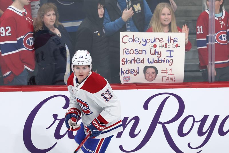 Dec 14, 2024; Winnipeg, Manitoba, CAN; Montreal Canadiens right wing Cole Caufield (13) skates past fans before a game against the Winnipeg Jets at Canada Life Centre. Mandatory Credit: James Carey Lauder-Imagn Images