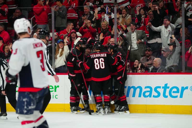 Apr 5, 2024; Raleigh, North Carolina, USA; Carolina Hurricanes center Sebastian Aho (20) celebrates his goal with left wing Teuvo Teravainen (86) center Seth Jarvis (24) center Jake Guentzel (59) and defenseman Brent Burns (8) against the Washington Capitals during the third period at PNC Arena. Mandatory Credit: James Guillory-USA TODAY Sports