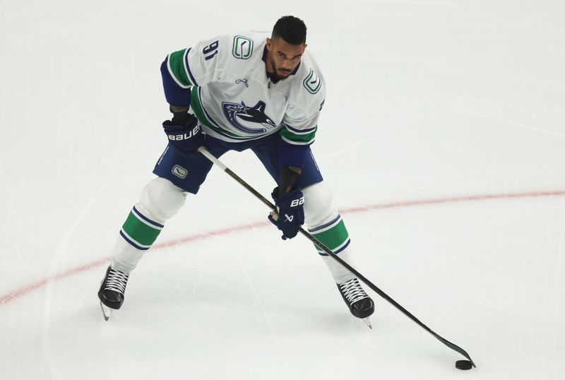 Oct 21, 2025; Pittsburgh, Pennsylvania, USA;  Vancouver Canucks left wing Evander Kane (91) warms up before a game against the Pittsburgh Penguins at PPG Paints Arena. Mandatory Credit: Charles LeClaire-Imagn Images