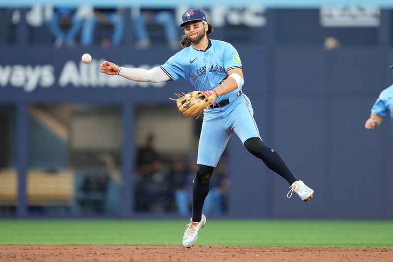 May 22, 2024; Toronto, Ontario, CAN; Toronto Blue Jays shortstop Bo Bichette (11) throws to first base to get out Chicago White Sox catcher Martín Maldonado (not pictured) during the third inning at Rogers Centre. Mandatory Credit: John E. Sokolowski-USA TODAY Sports