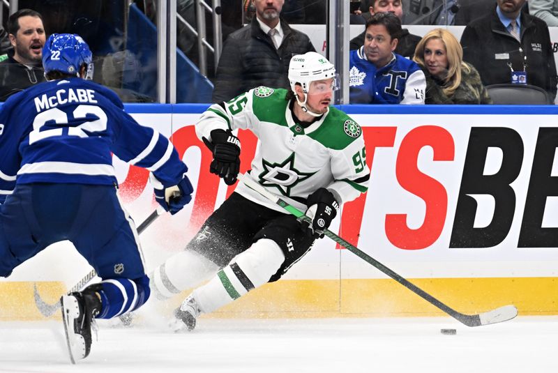 Feb 7, 2024; Toronto, Ontario, CAN; Dallas Stars forward Matt Duchene (95) turns with the puck away from Toronto Maple Leafs defenseman Jake McCabe (22) in the second period at Scotiabank Arena. Mandatory Credit: Dan Hamilton-USA TODAY Sports