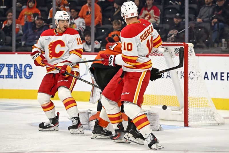 Nov 2, 2025; Philadelphia, Pennsylvania, USA; Calgary Flames left wing Jonathan Huberdeau (10) deflects the puck for a goal against the Philadelphia Flyers during the third period at Xfinity Mobile Arena. Mandatory Credit: Eric Hartline-Imagn Images