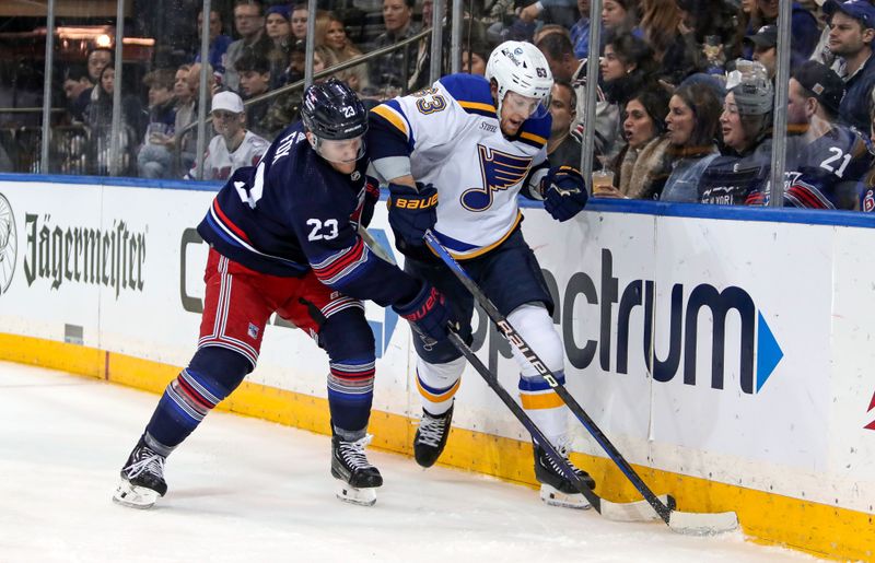 Mar 9, 2024; New York, New York, USA: New York Rangers defenseman Adam Fox (23) and St. Louis Blues left wing Jake Neighbours (63) battle for the puck during the first period at Madison Square Garden. Mandatory Credit: Danny Wild-USA TODAY Sports