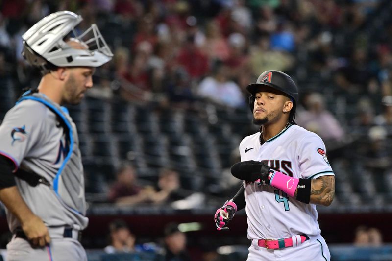 May 10, 2023; Phoenix, Arizona, USA; Arizona Diamondbacks second baseman Ketel Marte (4) scores after being walked home in the fourth inning against the Miami Marlins at Chase Field. Mandatory Credit: Matt Kartozian-USA TODAY Sports