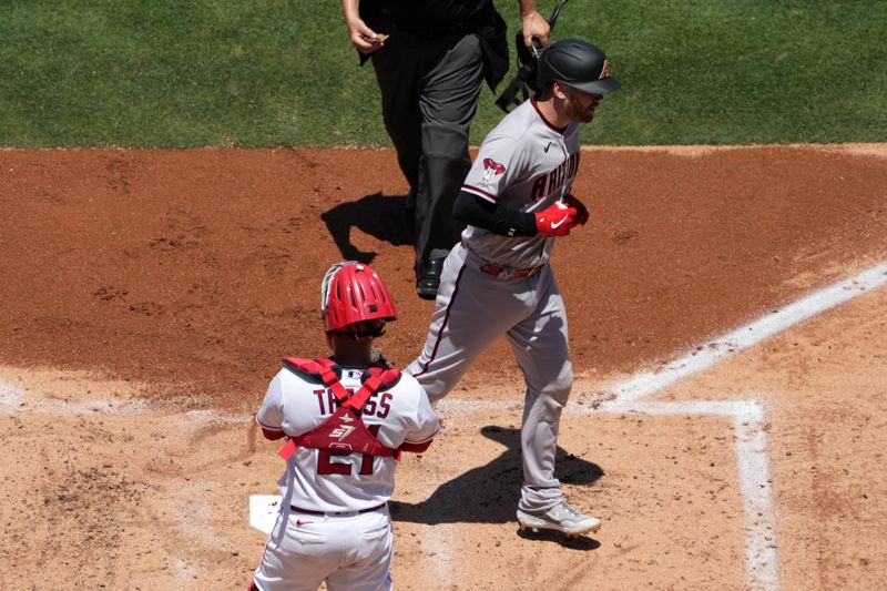 Jul 2, 2023; Anaheim, California, USA; Arizona Diamondbacks catcher Carson Kelly (18) crosses home plate after hitting a two-run home run in the second inning as Los Angeles Angels catcher Matt Thaiss (21) watches at Angel Stadium. Mandatory Credit: Kirby Lee-USA TODAY Sports