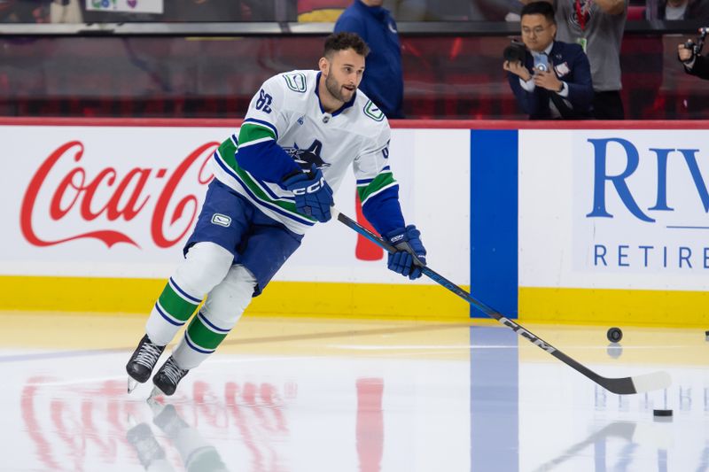 Nov 23, 2024; Ottawa, Ontario, CAN; Vancouver Canucks center Max Sasson (63) steps onto the ice during warmup for his first NHL game to be played against the Ottawa Senators at the Canadian Tire Centre. Mandatory Credit: Marc DesRosiers-Imagn Images