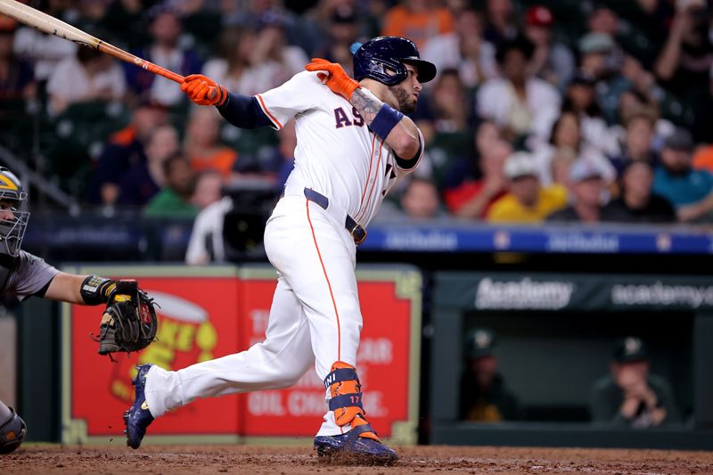 May 14, 2024; Houston, Texas, USA; Houston Astros pinch hitter Victor Caratini (17) hits a walkoff RBI single against the Oakland Athletics during the tenth inning at Minute Maid Park. Mandatory Credit: Erik Williams-USA TODAY Sports