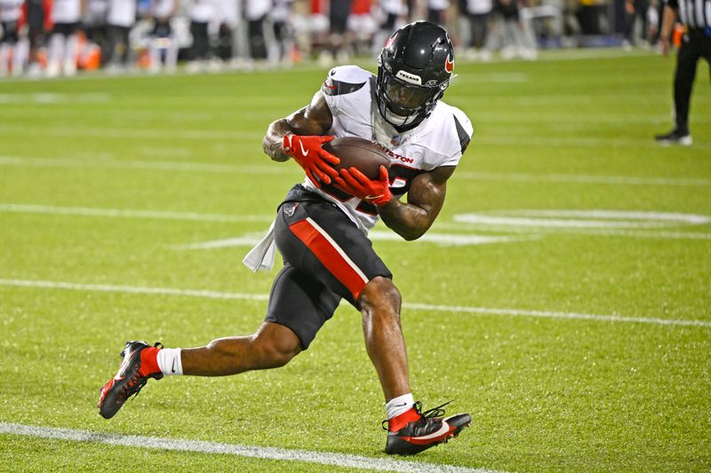 Houston Texans running back Cam Akers catches a pass for a touchdown during the first half of an NFL exhibition Hall of Fame football game against the Chicago Bears, Thursday, Aug. 1, 2024, in Canton, Ohio. (AP Photo/David Richard)