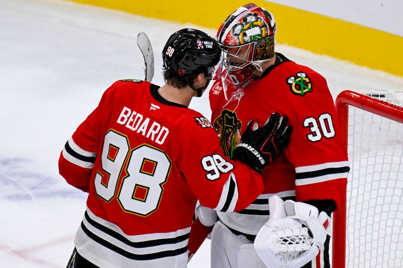 Oct 13, 2025; Chicago, Illinois, USA;  Chicago Blackhawks center Connor Bedard (98) congratulates Chicago Blackhawks goaltender Spencer Knight (30) after the third period against the Utah Mammoth at United Center. Mandatory Credit: Matt Marton-Imagn Images