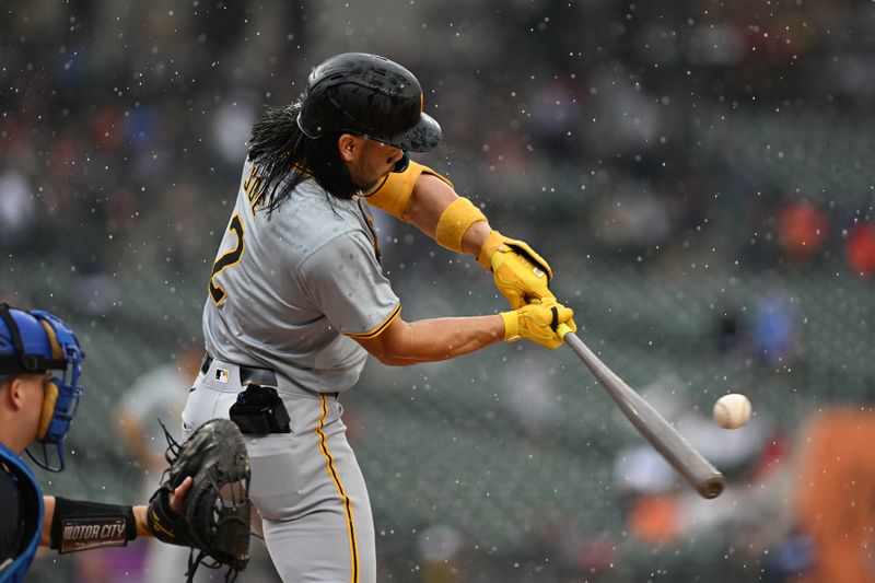 May 29, 2024; Detroit, Michigan, USA;  Pittsburgh Pirates first baseman Connor Joe (2) hits the ball in a downpour against the Detroit Tigers in the first inning at Comerica Park. Mandatory Credit: Lon Horwedel-USA TODAY Sports