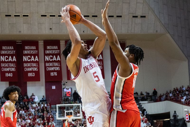 Jan 28, 2023; Bloomington, Indiana, USA; Indiana Hoosiers forward Malik Reneau (5) shoots the ball while Ohio State Buckeyes forward Brice Sensabaugh (10) defends in the first half at Simon Skjodt Assembly Hall. Mandatory Credit: Trevor Ruszkowski-USA TODAY Sports