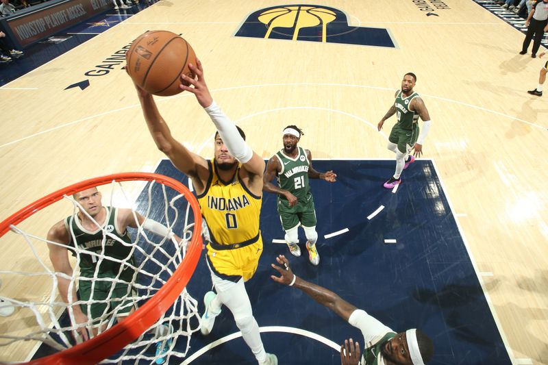 INDIANAPOLIS, IN - APRIL 26: Tyrese Haliburton #0 of the Indiana Pacers dunks the ball during the game against the Milwaukee Bucks during Round 1 Game 3 of the 2024 NBA Playoffs on April 26, 2024 at Gainbridge Fieldhouse in Indianapolis, Indiana. NOTE TO USER: User expressly acknowledges and agrees that, by downloading and or using this Photograph, user is consenting to the terms and conditions of the Getty Images License Agreement. Mandatory Copyright Notice: Copyright 2023 NBAE (Photo by Nathaniel S. Butler/NBAE via Getty Images)