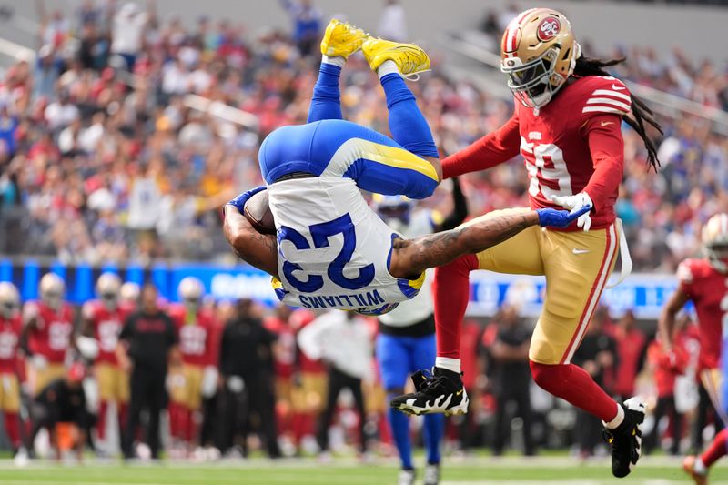 Los Angeles Rams running back Kyren Williams, left, flips into the end zone to score against San Francisco 49ers linebacker De'Vondre Campbell during the first half of an NFL football game, Sunday, Sept. 22, 2024, in Inglewood, Calif. (AP Photo/Ashley Landis)