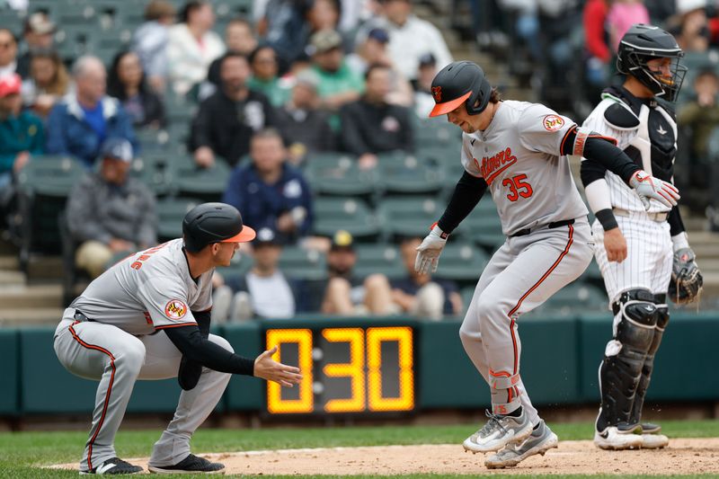 May 26, 2024; Chicago, Illinois, USA; Baltimore Orioles catcher Adley Rutschman (35) celebrates with third baseman Jordan Westburg (11) after hitting a two-run home run against the Chicago White Sox during the sixth inning at Guaranteed Rate Field. Mandatory Credit: Kamil Krzaczynski-USA TODAY Sports