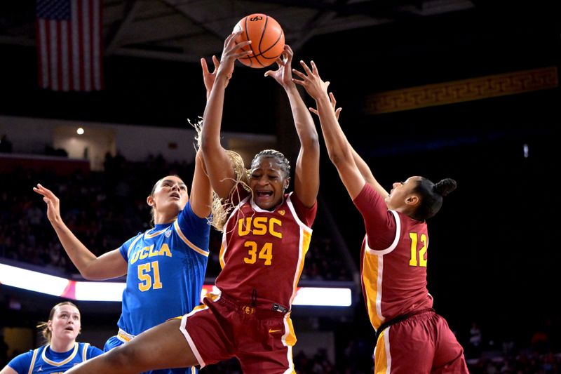 Jan 14, 2024; Los Angeles, California, USA; UCLA Bruins center Lauren Betts (51), USC Trojans center Clarice Akunwafo (34) and guard JuJu Watkins (12) go for a rebound in the first half at Galen Center. Mandatory Credit: Jayne Kamin-Oncea-USA TODAY Sports