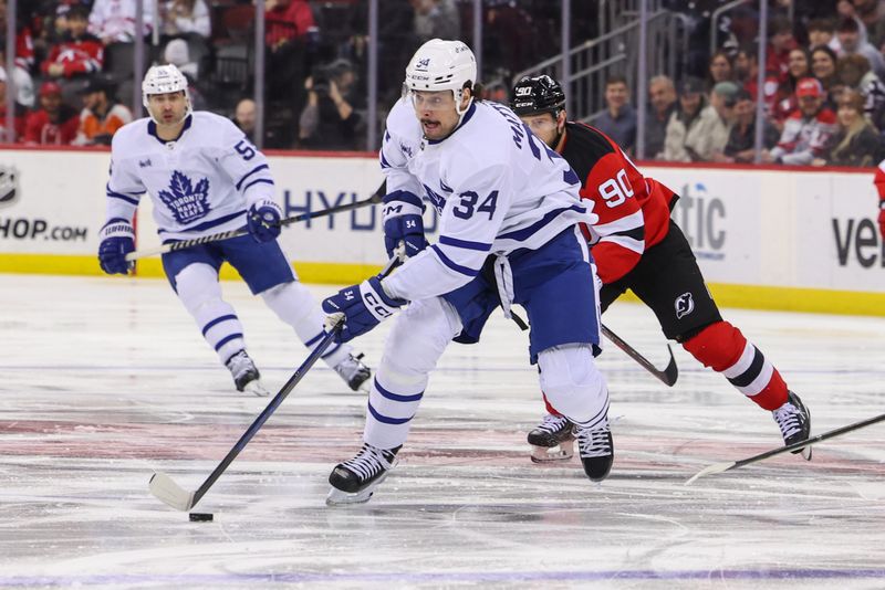 Mar 7, 2023; Newark, New Jersey, USA; Toronto Maple Leafs center Auston Matthews (34) skates with the puck against the New Jersey Devils during the first period at Prudential Center. Mandatory Credit: Ed Mulholland-USA TODAY Sports