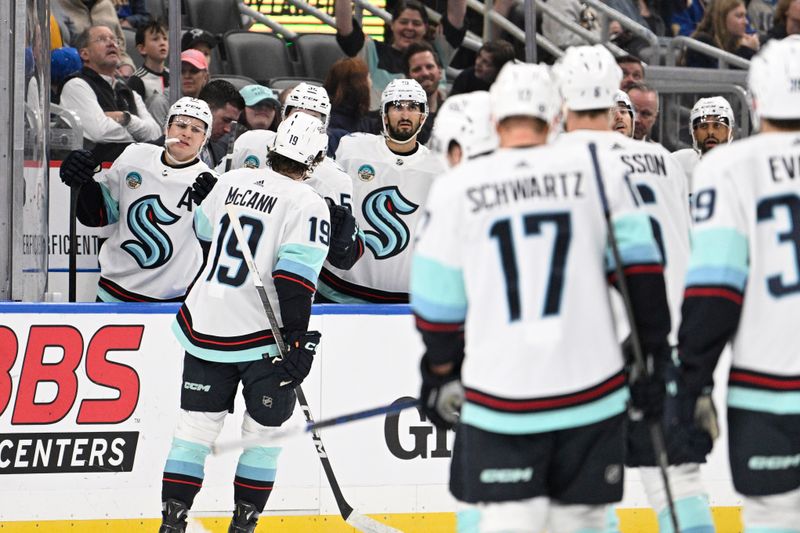 Apr 14, 2024; St. Louis, Missouri, USA; Seattle Kraken left wing Jared McCann (19) is congratulated by teammates after scoring a goal against the St. Louis Blues during the first period at Enterprise Center. Mandatory Credit: Jeff Le-USA TODAY Sports