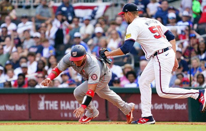 May 27, 2024; Cumberland, Georgia, USA; Washington Nationals catcher Keibert Ruiz (20) gets run down by Atlanta Braves pitcher Charlie Morton (50) during the third inning at Truist Park. Mandatory Credit: John David Mercer-USA TODAY Sports