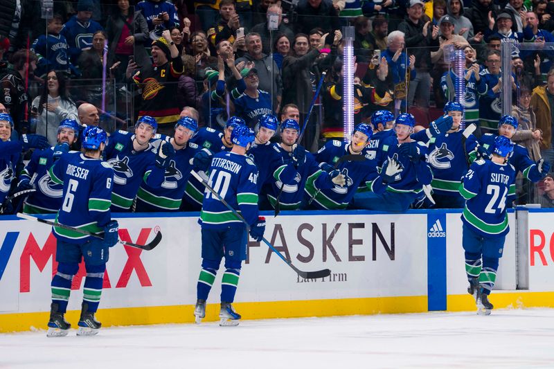 Jan 24, 2024; Vancouver, British Columbia, CAN; Vancouver Canucks forward Brock Boeser (6) and forward Elias Pettersson (40) and forward Pius Suter (24) celebrate Suter   s third goal of the game with the bench against the St. Louis Blues in the third period at Rogers Arena. Blues 4-3 in overtime. Mandatory Credit: Bob Frid-USA TODAY Sports