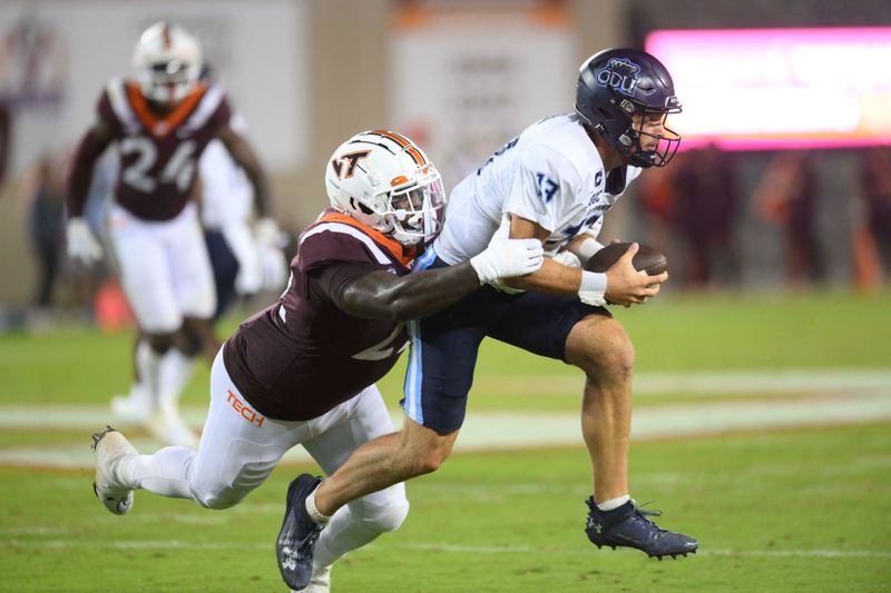 Sep 2, 2023; Blacksburg, Virginia, USA; Old Dominion Monarchs quarterback Grant Wilson (13) gets tackled by Virginia Tech Hokies defensive lineman Mario Kendricks (22)  in the third quarter at Lane Stadium. Mandatory Credit: Lee Luther Jr.-USA TODAY Sports