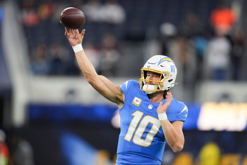 Los Angeles Chargers quarterback Justin Herbert (10) warms up before an NFL football game against the Cincinnati Bengals, Sunday, Nov. 17, 2024, in Inglewood, Calif. (AP Photo/Gregory Bull)