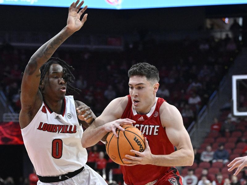 Jan 13, 2024; Louisville, Kentucky, USA;  North Carolina State Wolfpack guard Michael O'Connell (12) drives to the basket against Louisville Cardinals guard Mike James (0) during the first half at KFC Yum! Center. Mandatory Credit: Jamie Rhodes-USA TODAY Sports