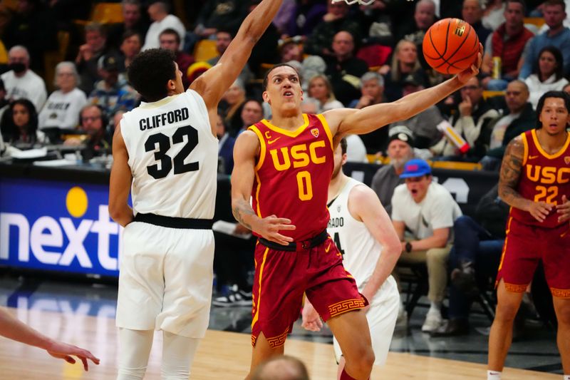 Feb 23, 2023; Boulder, Colorado, USA; USC Trojans forward Kobe Johnson (0) shoots the ball past Colorado Buffaloes guard Nique Clifford (32) in the first half at the CU Events Center. Mandatory Credit: Ron Chenoy-USA TODAY Sports