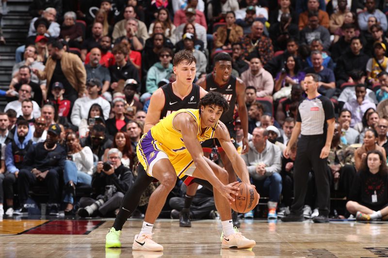 MIAMI, FL - DECEMBER 4: Max Christie #12 of the Los Angeles Lakers handles the ball during the game against the Miami Heat on December 4, 2024 at Kaseya Center in Miami, Florida. NOTE TO USER: User expressly acknowledges and agrees that, by downloading and or using this Photograph, user is consenting to the terms and conditions of the Getty Images License Agreement. Mandatory Copyright Notice: Copyright 2024 NBAE (Photo by Joe Murphy/NBAE via Getty Images)