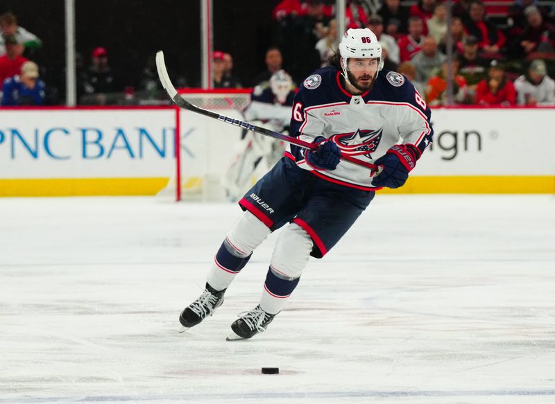 Nov 26, 2023; Raleigh, North Carolina, USA; Columbus Blue Jackets left wing Kirill Marchenko (86) skates with the puck against the Carolina Hurricanes during the second period at PNC Arena. Mandatory Credit: James Guillory-USA TODAY Sports