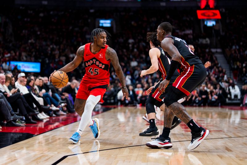 TORONTO, ON - DECEMBER 1: Davion Mitchell #45 of the Toronto Raptors dribbles the ball against Terry Rozier #2 of the Miami Heat at Scotiabank Arena on December 1, 2024 in Toronto, Ontario, Canada. NOTE TO USER: User expressly acknowledges and agrees that, by downloading and/or using this Photograph, user is consenting to the terms and conditions of the Getty Images License Agreement. (Photo by Andrew Lahodynskyj/Getty Images)