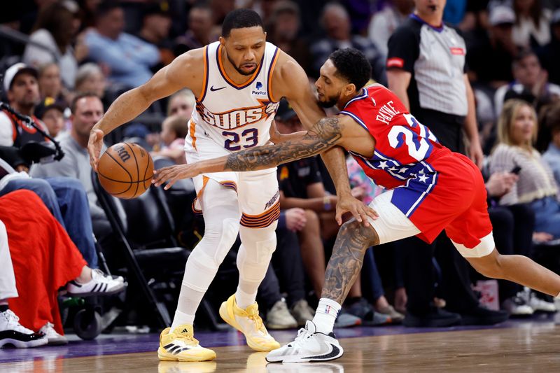 PHOENIX, ARIZONA - MARCH 20: Cameron Payne #22 of the Philadelphia 76ers attempts to knock the ball away from Eric Gordon #23 of the Phoenix Suns during the first half at Footprint Center on March 20, 2024 in Phoenix, Arizona. NOTE TO USER: User expressly acknowledges and agrees that, by downloading and or using this photograph, User is consenting to the terms and conditions of the Getty Images License Agreement.  (Photo by Chris Coduto/Getty Images)