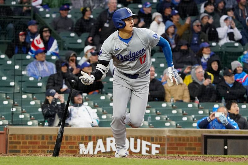 Apr 7, 2024; Chicago, Illinois, USA; Los Angeles Dodgers designated hitter Shohei Ohtani (17) hits a one run double against the Chicago Cubs during the eighth inning at Wrigley Field. Mandatory Credit: David Banks-USA TODAY Sports