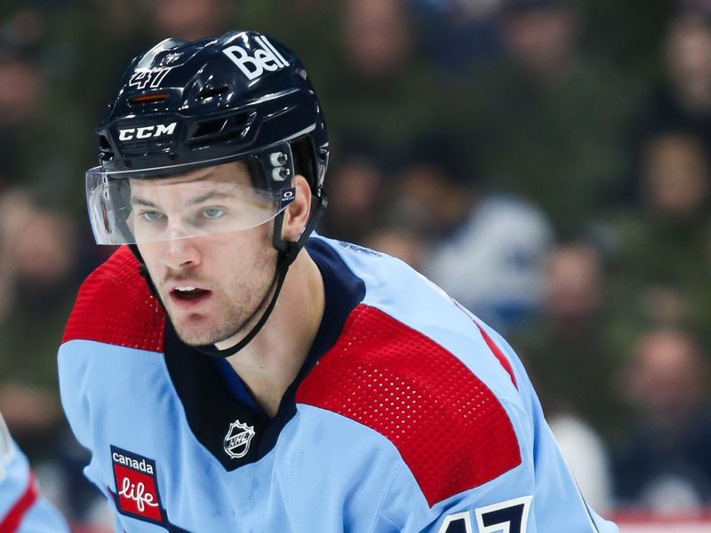 Dec 4, 2023; Winnipeg, Manitoba, CAN;   Winnipeg Jets defenseman Declan Chisholm (47) waits for the face-off against the Carolina Hurricanes during the first period at Canada Life Centre. Mandatory Credit: Terrence Lee-USA TODAY Sports