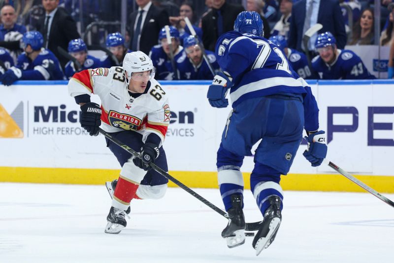 Dec 15, 2025; Tampa, Florida, USA; Florida Panthers left wing Brad Marchand (63) controls the puck against the Tampa Bay Lightning in the second period at Benchmark International Arena. Mandatory Credit: Nathan Ray Seebeck-Imagn Images