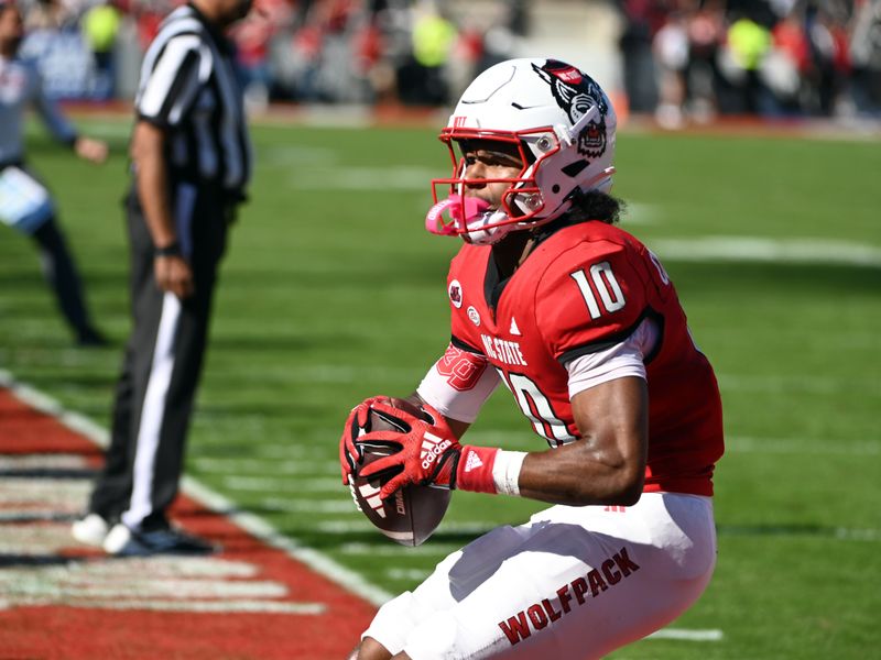 Oct 28, 2023; Raleigh, North Carolina, USA; North Carolina State Wolfpack receiver KC Concepcion (10) reacts after scoring a touchdown during the first half against the Clemson Tigers at Carter-Finley Stadium. Mandatory Credit: Rob Kinnan-USA TODAY Sports