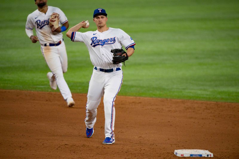 Aug 15, 2023; Arlington, Texas, USA; Texas Rangers shortstop Corey Seager (5) throws to first base for the last out in the game against the Los Angeles Angels at Globe Life Field. Mandatory Credit: Jerome Miron-USA TODAY Sports