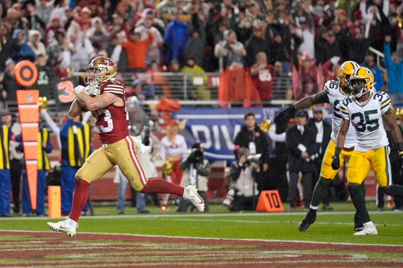 San Francisco 49ers running back Christian McCaffrey (23) scores a rushing touchdown during the second half of an NFL football NFC divisional playoff game against the Green Bay Packers Saturday, Jan. 20, 2024, in Santa Clara, Calif. (AP Photo/Godofredo A. Vásquez)