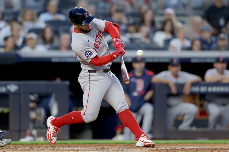 Jun 7, 2025; Bronx, New York, USA; Boston Red Sox third baseman Abraham Toro (29) hits an RBI single against the New York Yankees during the third inning at Yankee Stadium. Mandatory Credit: Brad Penner-Imagn Images