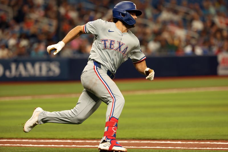 Apr 2, 2024; St. Petersburg, Florida, USA; Texas Rangers shortstop Josh Smith (8) doubles during the third inning against the Tampa Bay Rays  at Tropicana Field. Mandatory Credit: Kim Klement Neitzel-USA TODAY Sports