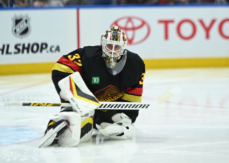 Mar 5, 2025; Vancouver, British Columbia, CAN;Vancouver Canucks goaltender Kevin Lanikinen (32)  stretches during the second period against the Anaheim Ducks at Rogers Arena. Mandatory Credit: Simon Fearn-Imagn Images