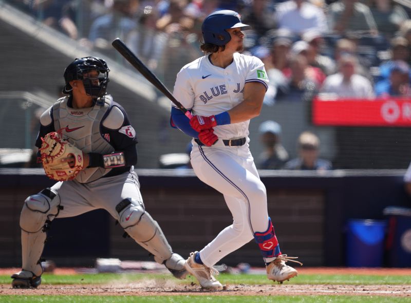 Jun 15, 2024; Toronto, Ontario, CAN; Toronto Blue Jays third baseman Addison Barger (47) hits an RBI single against the Cleveland Guardians during the second inning at Rogers Centre. Mandatory Credit: Nick Turchiaro-USA TODAY Sports