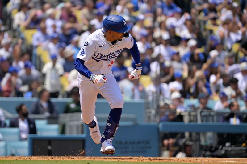 Apr 30, 2025; Los Angeles, California, USA; Los Angeles Dodgers shortstop Mookie Betts (50) hits a two-run RBI single against the Miami Marlins during the third inning at Dodger Stadium. Mandatory Credit: Jayne Kamin-Oncea-Imagn Images