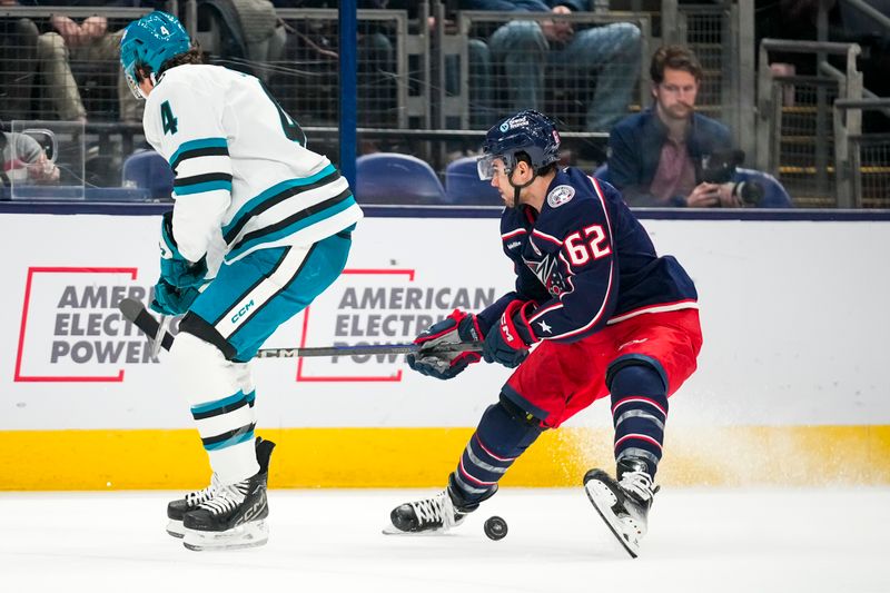Jan 16, 2025; Columbus, Ohio, USA; Columbus Blue Jackets right wing Kevin Labanc (62) stops the puck against San Jose Sharks defenseman Cody Ceci (4) in the first period at Nationwide Arena on Thursday, Jan. 16, 2025 in Columbus, Ohio.   Mandatory Credit: Samantha Madar/USA TODAY Network via Imagn Images 