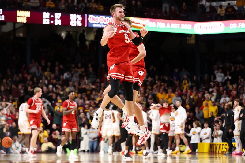 Jan 23, 2024; Minneapolis, Minnesota, USA; Wisconsin Badgers forward Tyler Wahl (5) celebrates the win against the Minnesota Golden Gophers with forward Nolan Winter (31) after the game at Williams Arena. Mandatory Credit: Matt Krohn-USA TODAY Sports